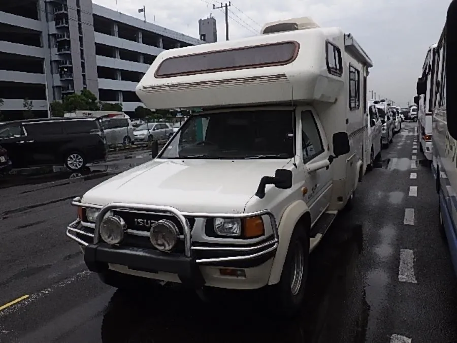 White Isuzu Rodeo 4WD undergoing front-end repair services.